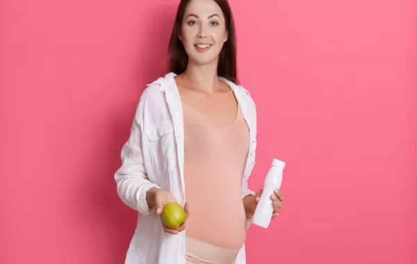 صورة لامرأة حامل تحمل طعاماً