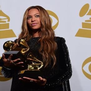 Beyonce poses with her three Grammys in the press room during the 57th annual Grammy Awards in Los Angeles, California on February 8, 2015. AFP PHOTO / FREDERIC J. BROWN