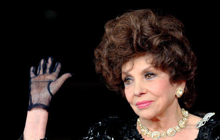 In this file photo taken on November 16, 2012, Italian actress Gina Lollobrigida waves upon her arrival for the premiere of the documentary film "Enzo Mirigliani" during the 7th Rome film festival. Tiziana FABI / AFP
