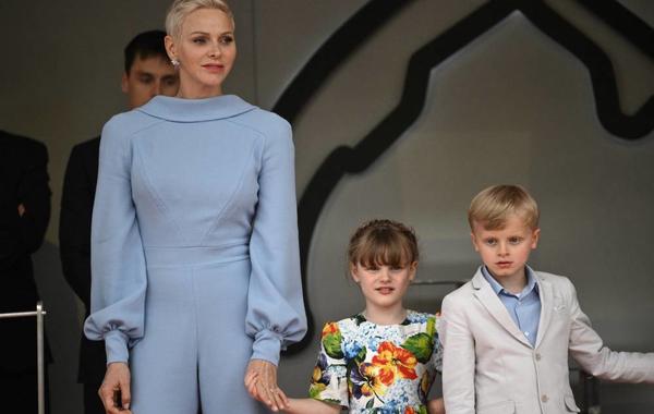 Princess Charlene (L) of Monaco stands with her children Jacques and Gabriella on the podium after the Monaco Formula 1 Grand Prix at the Monaco street circuit in Monaco, on May 29, 2022. LOIC VENANCE / AFP