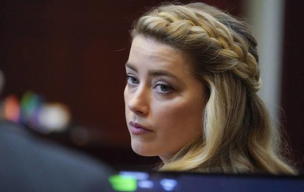 Actor Amber Heard arrives for closing arguments in the Depp v. Heard trial at the Fairfax County Circuit Courthouse in Fairfax, Virginia, on May 27, 2022. Actor Johnny Depp is suing ex-wife Amber Heard for libel after she wrote an op-ed piece in The Washington Post in 2018 referring to herself as a “public figure representing domestic abuse.” Steve Helber / POOL / AFP