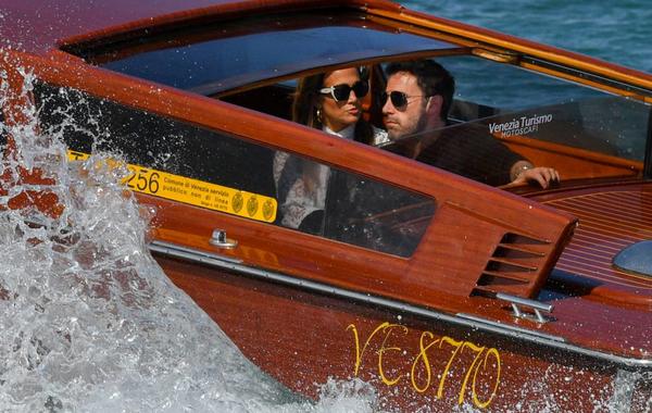 US actor Ben Affleck and US actress and singer Jennifer Lopez travel aboard a vaporetto taxi boat on September 9, 2021 after they arrived to attend the 78th Venice Film Festival in Venice. Filippo MONTEFORTE / AFP
