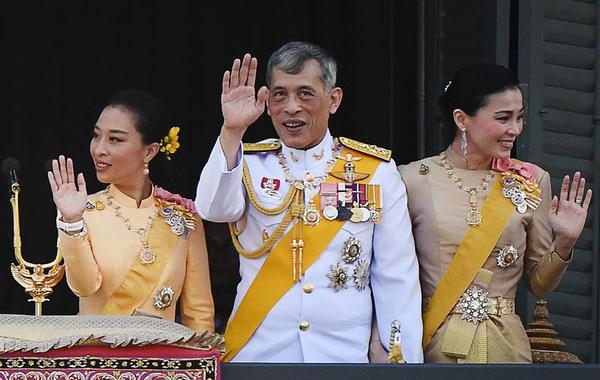 In this file photo taken on May 6, 2019, Thailand's King Maha Vajiralongkorn (C), Queen Suthida and his daughter Princess Bajrakitiyabha Mahidol (L) wave to well-wishers from the balcony of Suddhaisavarya Prasad Hall of the Grand Palace as they grant a public audience on the final day of his royal coronation in Bangkok.  Jewel SAMAD / AFP