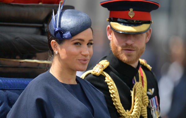 Britain's Meghan, Duchess of Sussex (L) and Britain's Prince Harry, Duke of Sussex (R) return to Buckingham Palace after the Queen's Birthday Parade, 'Trooping the Colour', in London on June 8, 2019. The ceremony of Trooping the Colour is believed to have first been performed during the reign of King Charles II. Since 1748, the Trooping of the Colour has marked the official birthday of the British Sovereign. Over 1400 parading soldiers, almost 300 horses and 400 musicians take part in the event. Daniel LEAL
