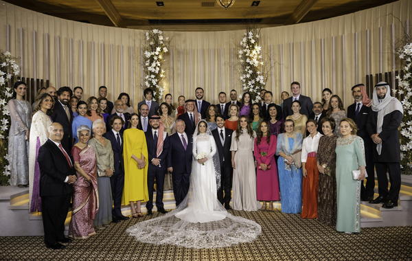   A handout picture released by Jordan's Royal Palace shows King Abdullah II (7th L) and Queen Rania (6th R) posing for a picture with members of the Jordanian royal family and the bride and groom, during the wedding ceremony of their eldest daughter Princess Iman and Jameel Alexander Thermiotis (C) in Amman on March 12, 2023. Thermiotis, who was born in 1994 in Venezuela to a family of Greek origin, currently works in the field of finance in New York. AFP PHOTO / JORDANIAN ROYAL PALACE