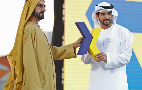 Sheikh Mohammed bin Rashid Al-Maktoum (L), and the Emirate's Crown Prince Sheikh Hamdan bin Mohammed bin Rashid Al-Maktoum (R), hold the new logo of Dubai Airoprt, in Dubai, on February 13, 2019. KARIM SAHIB / AFP